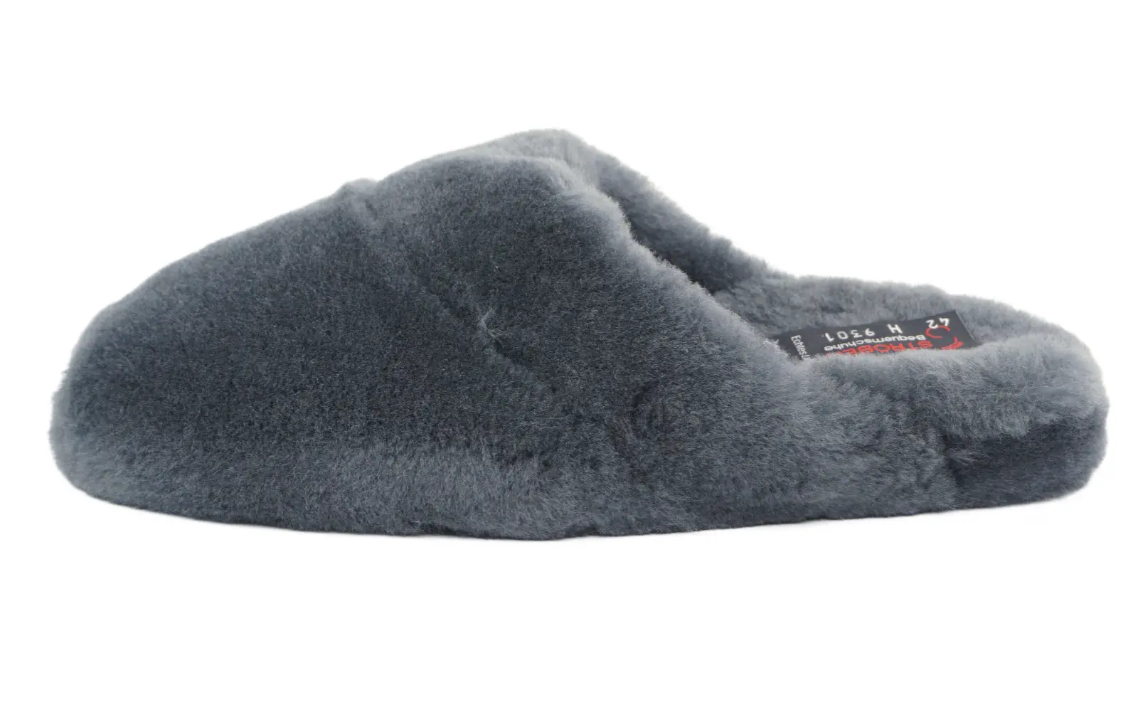 THOMAS Lammfell Schuh in anthrazit, elegant platziert auf einem hellen Holzuntergrund, zeigt die weiche Textur und stilvolle Form.